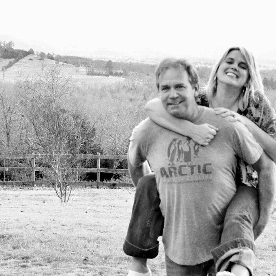 Randall Oliver, founder and owner of Arctic Heating and Cooling, with his wife in the Ozark hills